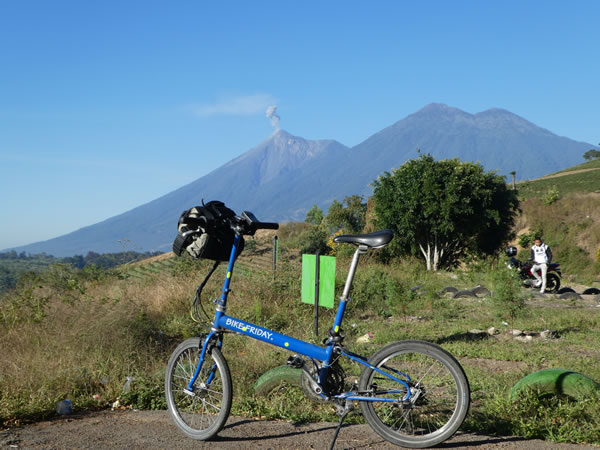 Ted’s bike with active volcano in background near Antigua, Guatemala.