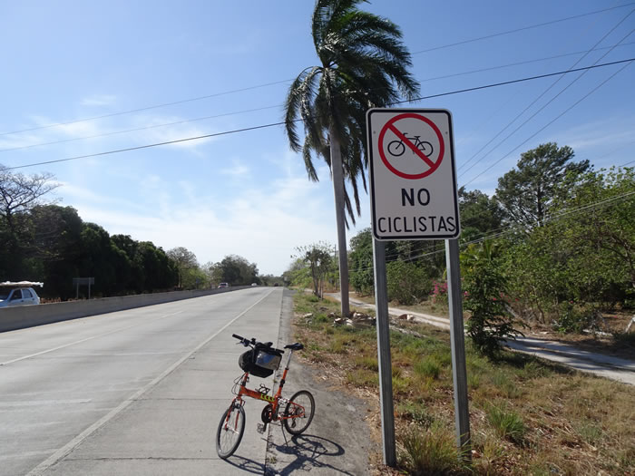 Ted’s bike next to a sign on the Pan American highway near Liberia, Costa Rica.