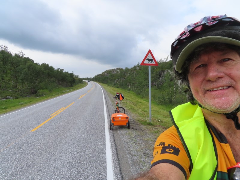 Ted with his bike on highway south of Skaidi, Norway.  The roads have no shoulders, but luckily the road only have light traffic that is accustom to stopping for reindeer and people riding bikes.