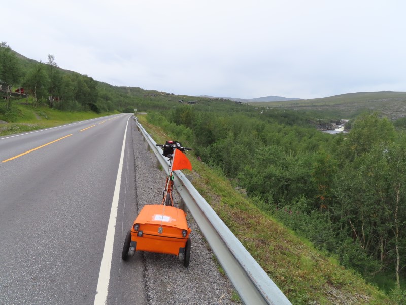 Teds bike on highway near above waterfall on highway slightly north of Alta, Norway.