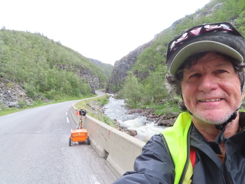 Ted and his bike as he goes up the 8% grade hill south of Alta, Norway.