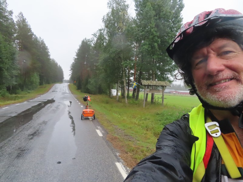 Ted with his bike on road between Sanabadets, Sweden and Ume, Sweden.  It rained all day.