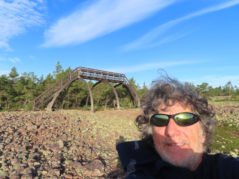 Ted with viewing tower behind him at Norrfllsviken nature area near campground at Norrfllsviken, Sweden.