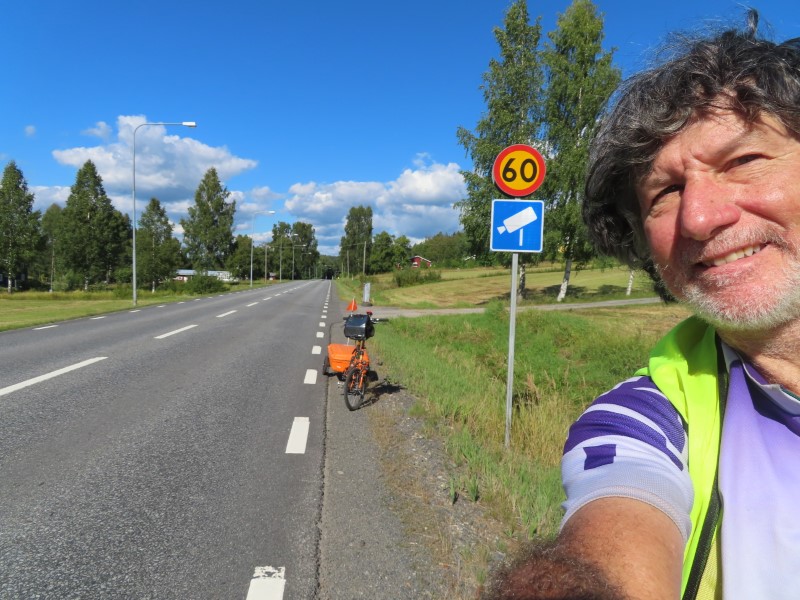 Ted pointing at sign warning about the previous photos speed camera on highway 331 between sng, Sweden and Srberge, Sweden.
