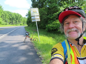 Ted and his bike on highway near Parkton, Maryland.