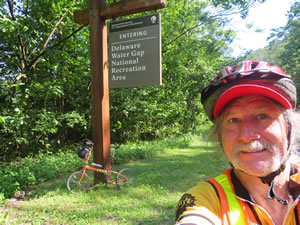 Ted and his bike at entrance sign for Delaware Water Gap National Recreation Area, Pennsylvania. 
