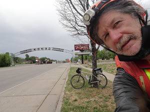 Ted with his bike near the Welcome to Ogden, Utah arch/sign.