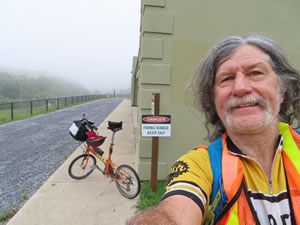 Ted and his bike next to shooting range at Virginia Military institute in Lexington, Virginia.