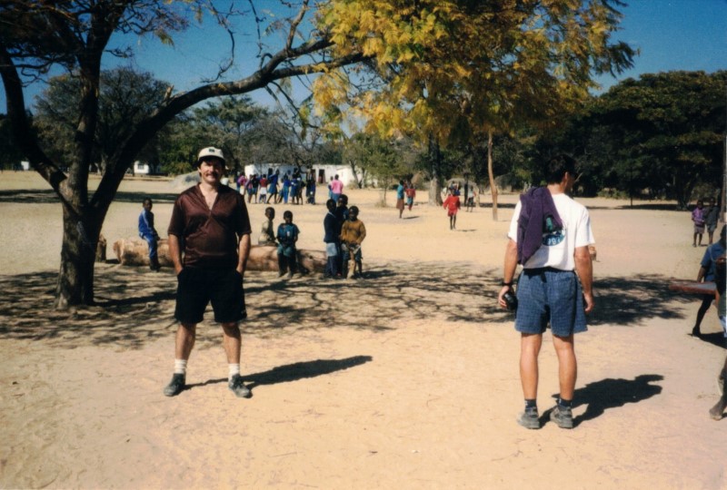 Ted at the playground of the primary school on Kumalo community land.  Gary standing pointed towards the playground.