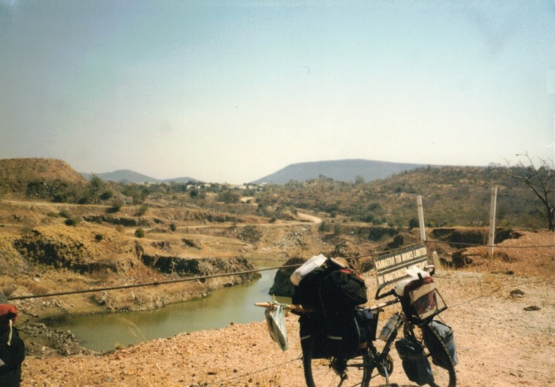 Teds bike with a pond and tin mine in the background between Dete and Sianzyundu.
