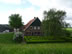 Netherlands – House with trimmed bush garden.