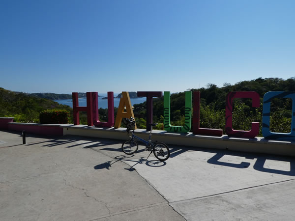 Ted’s bike at sign for Huatulco, Mexico, near Tangolunda, Mexico.