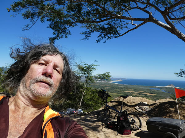 Ted with his bike and ocean in the background – southern Mexico.