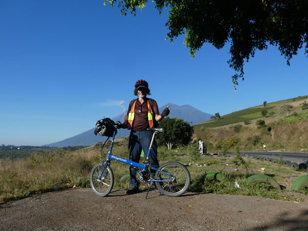 Ted with his bike and Volcanos in background near Antigua, Guatemala.