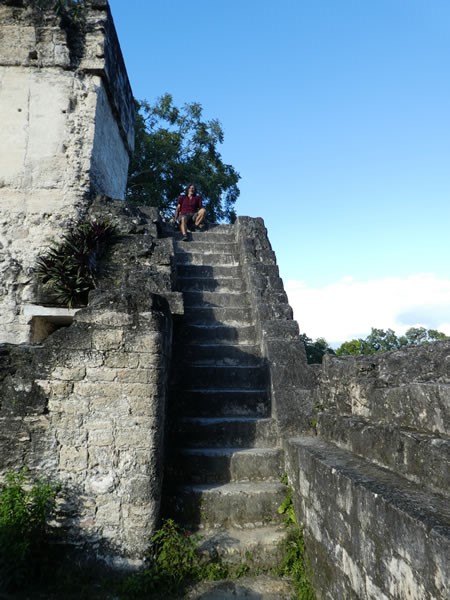 Ted sitting on stairs at ruins in Tikal National Park, Guatemala.