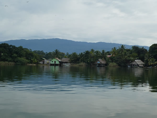 Homes on the shore of the Rio Dulce between the town of Rio Dulce and Livingston, Guatemala.