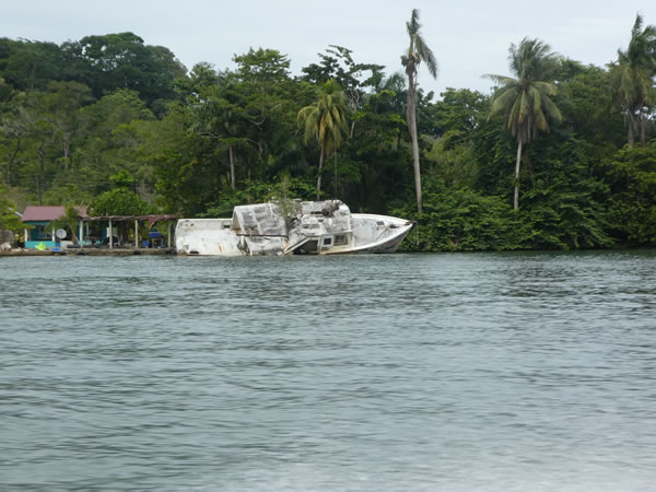 Boat wreck on the shore of the Rio Dulce near Livingston, Guatemala.
