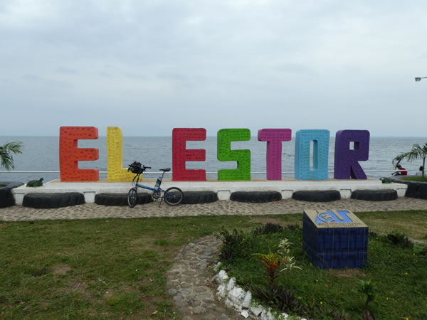 Ted’s bike in front of the town sign for El Estor, Guatemala.