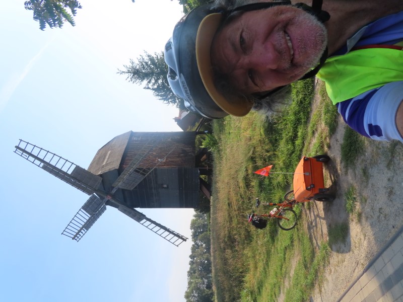 Ted and his bike in front of a windmill in Mtzel, Germany.